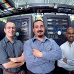 Portrait of three technicians standing in a server room