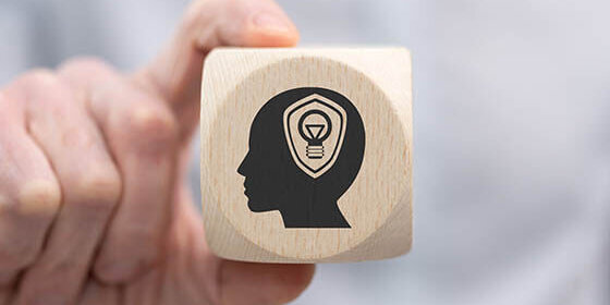 Hand,Holding,A,Wooden,Cube,With,Symbol,Of,Intellectual,Property