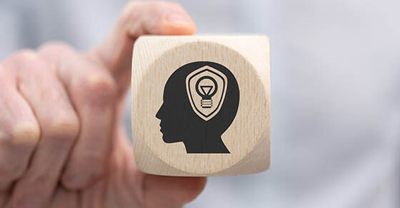 Hand,Holding,A,Wooden,Cube,With,Symbol,Of,Intellectual,Property